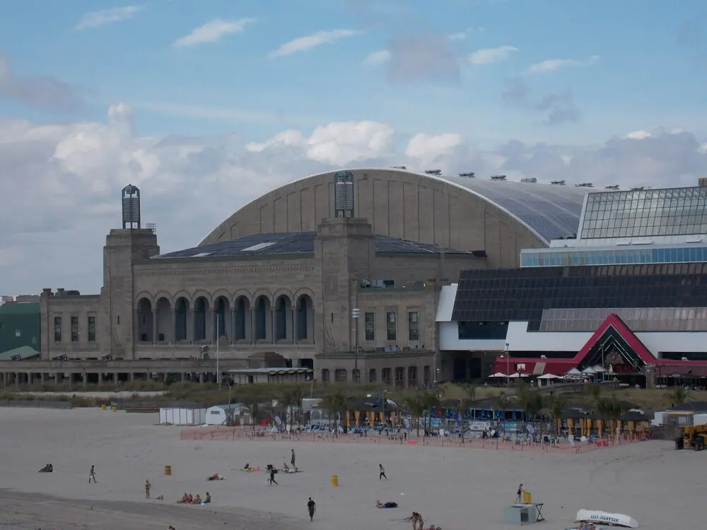 Boardwalk Hall's arched roof and stone front seen from the Atlantic City beach