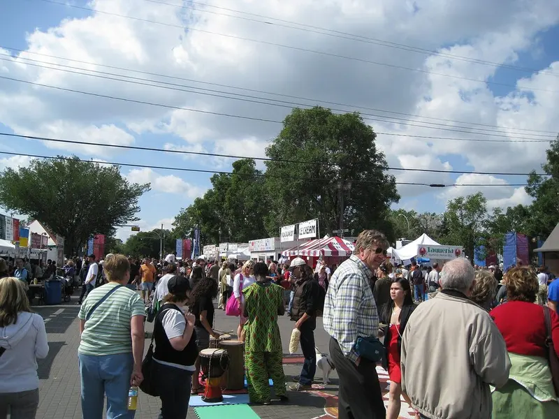 Festival-goers filling the street between food tents and banners at the 2009 Edmonton Fringe in Old Strathcona