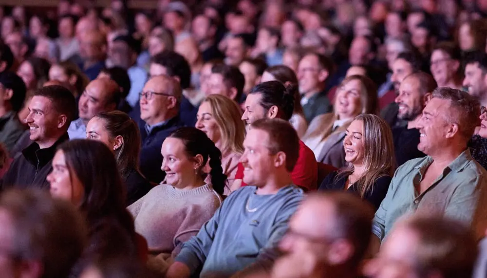 A smiling, laughing audience seated at The Regal during the festival.