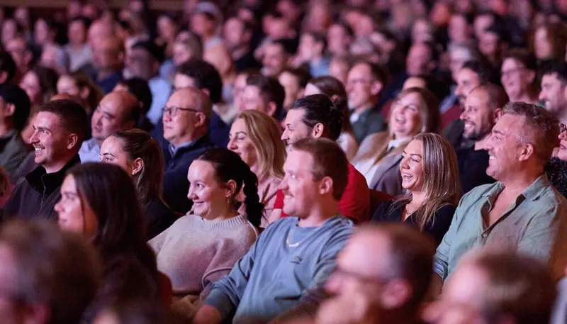 A smiling, laughing audience seated at The Regal during the festival.