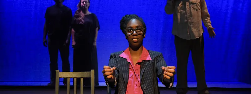 Performers on the blue-lit stage of Potrero Stage, the San Francisco theatre where the PlayGround Comedy Festival is held