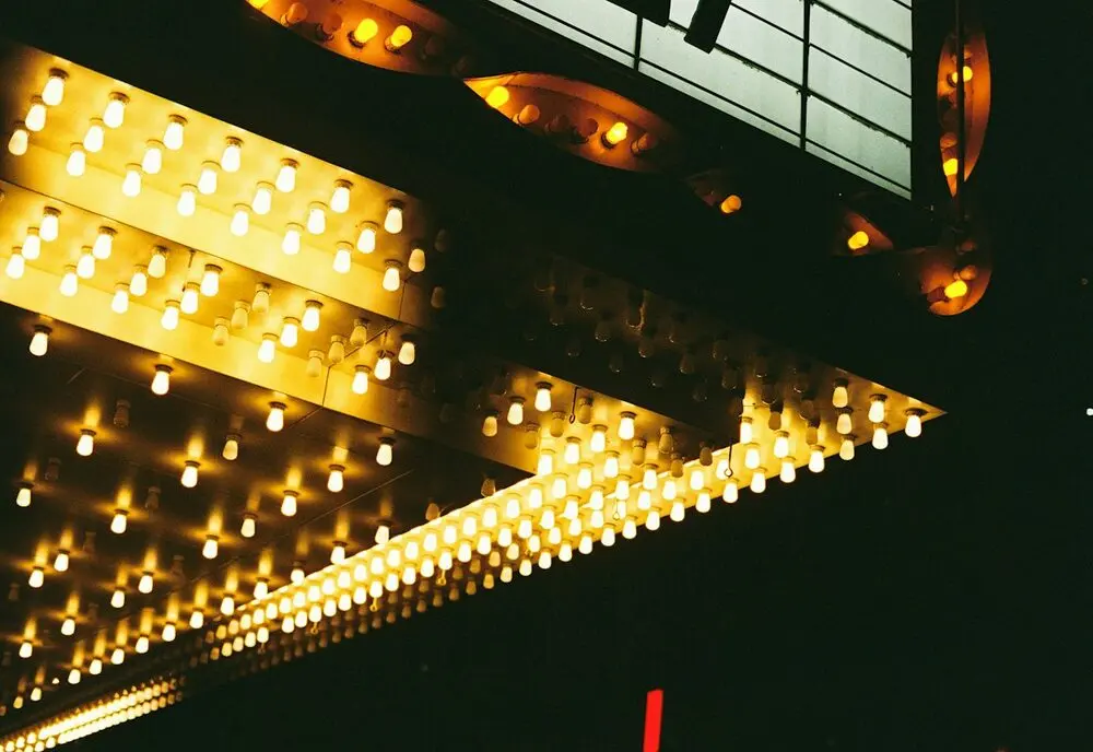 The underside of a theatre marquee studded with warm bulbs, no lettering