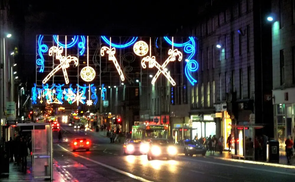 Union Street, Aberdeen, on the last night of 2009: festive lights strung across the street, buses and cars below